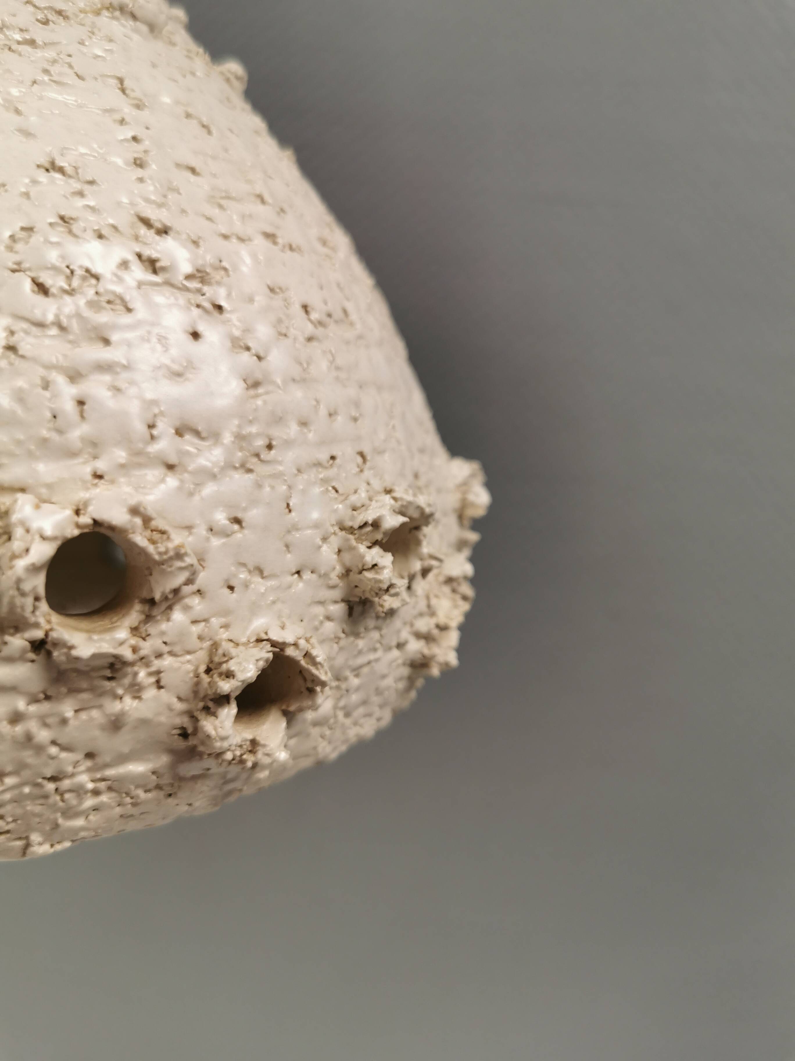 Two ceramic hanging lamps, in creamy white color, looking almost like coral