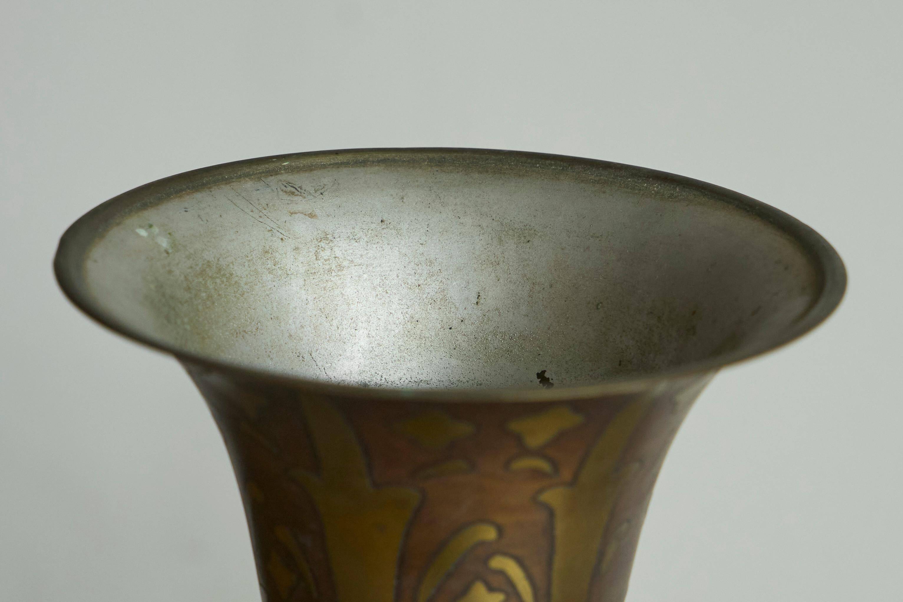 Art Deco fluted vase in patinated metal and brass from the 1930s.