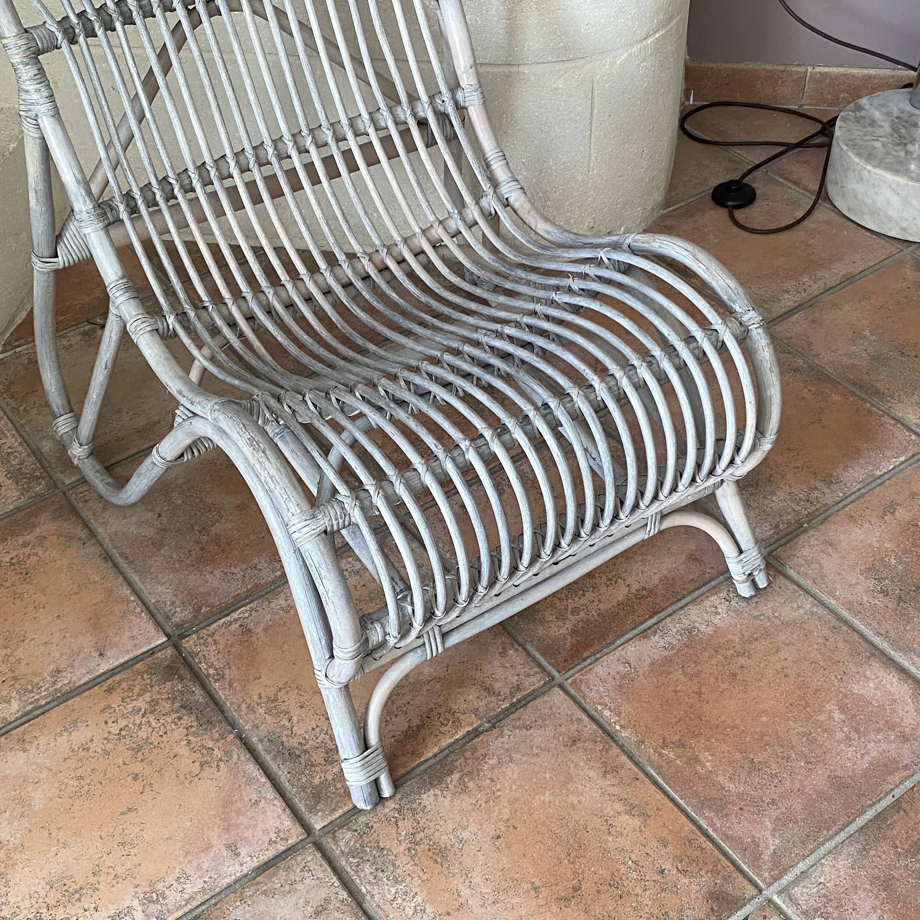 Vintage arched rattan armchair. 1970s.