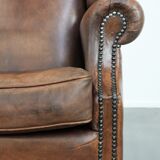 Vintage wingback armchair made of sheepskin leather with beautiful colours