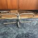 Oval glass coffee table with chrome legs, vintage 70s design.