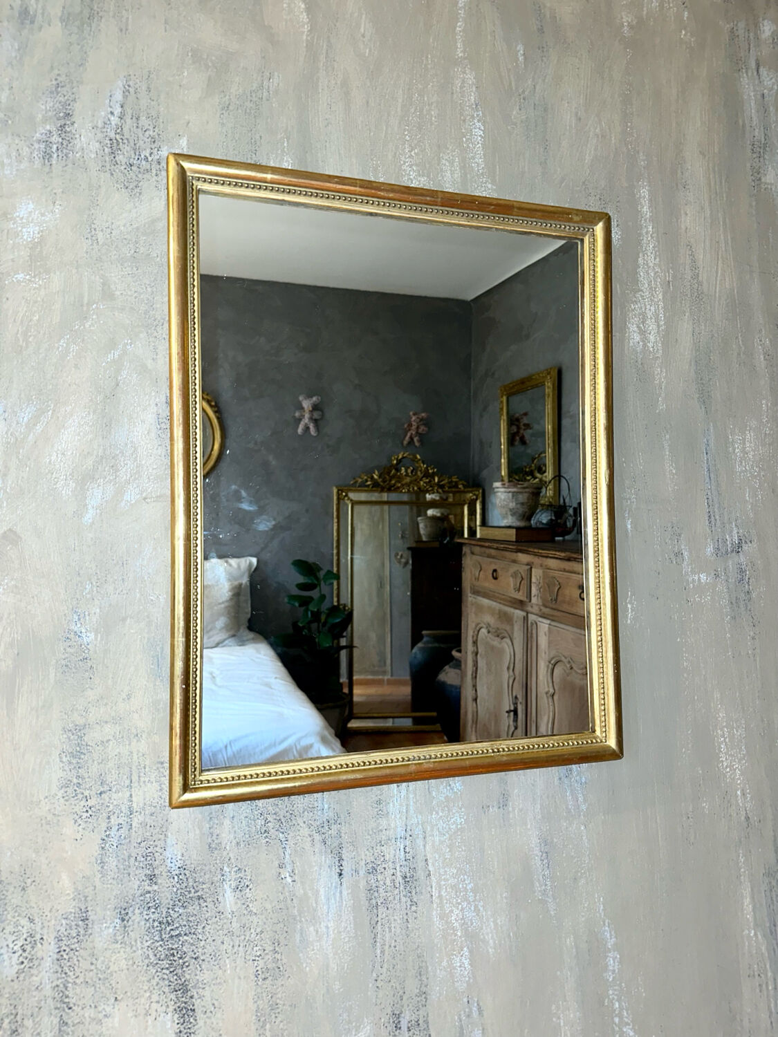Antique gilded mirror with pearl and gold leaf.