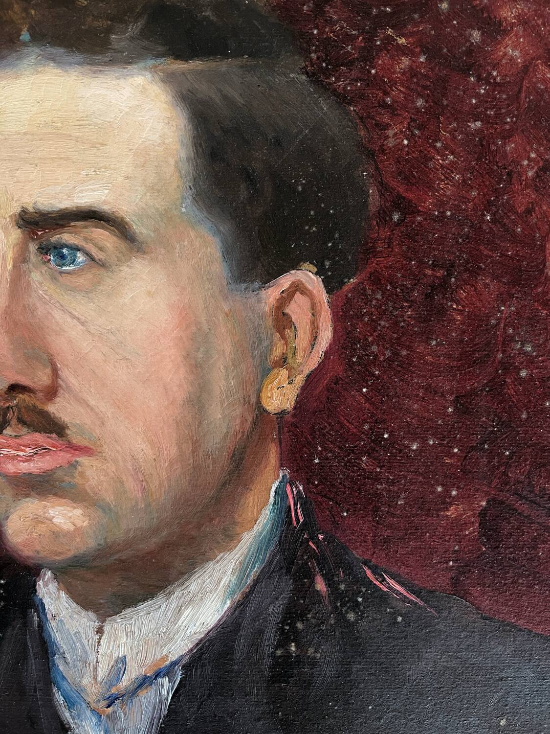 Old oil painting on cardboard portrait of a man in a dark suit