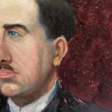Old oil painting on cardboard portrait of a man in a dark suit