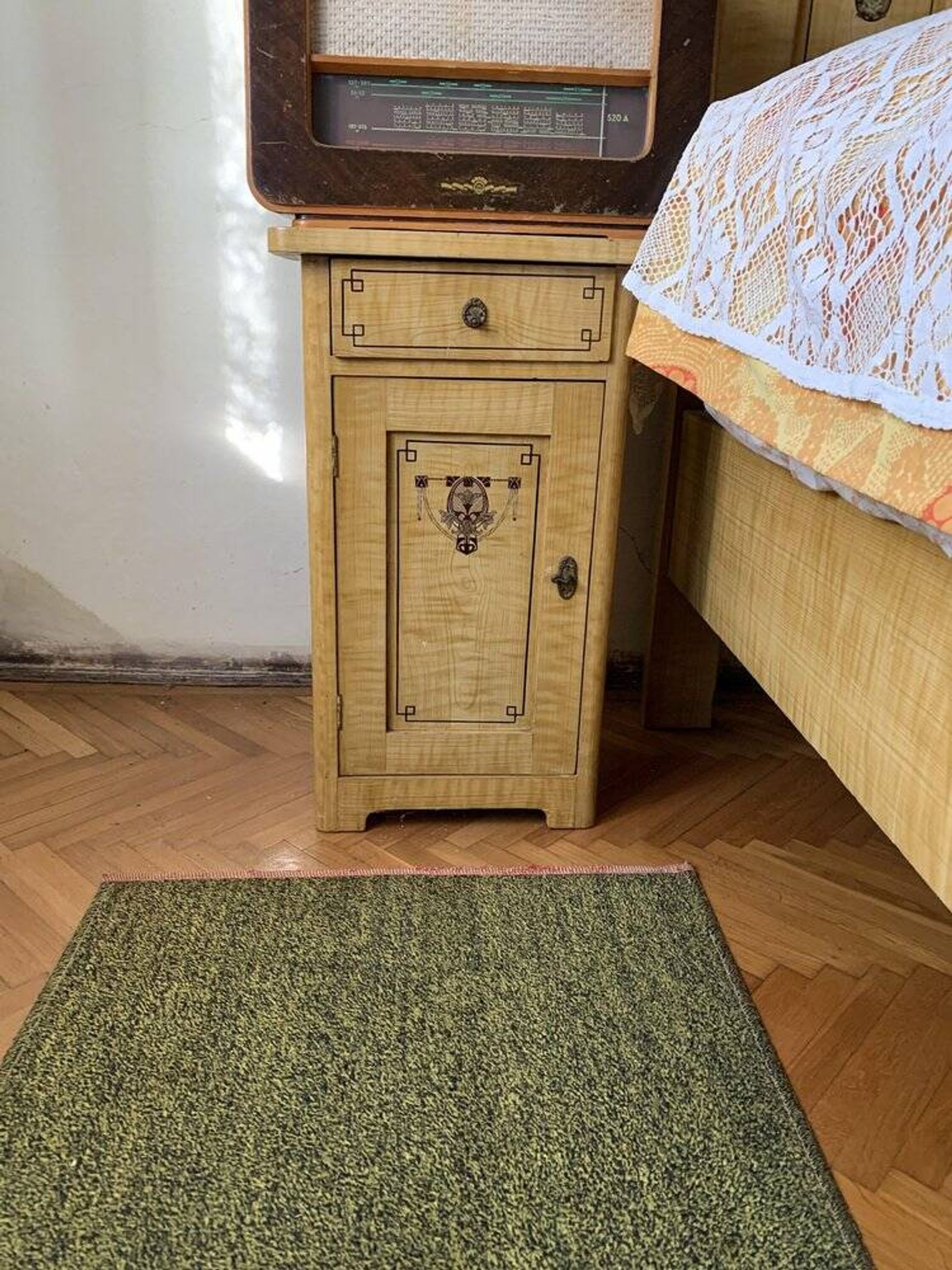 Vintage wooden bedside table painted brown, with a drawer and door, painted decoration from the 1890s.