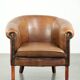 Sheepskin club armchair in a brown colour finished with decorative nails