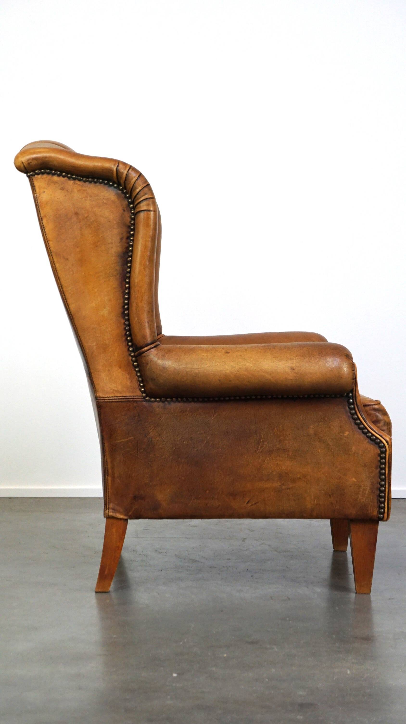 Sheepskin wingback chair with a unique design and a beautiful patina
