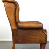 Sheepskin wingback chair with a unique design and a beautiful patina