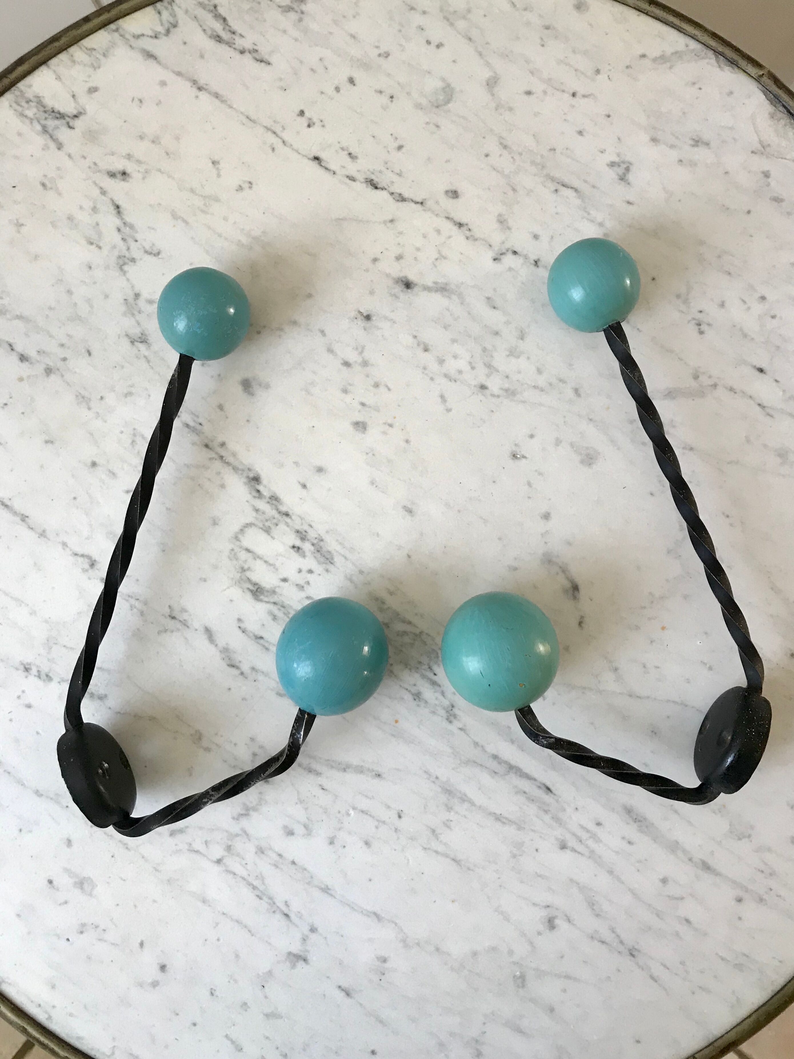 Duo of hooks balls in blue wood and black iron 60s