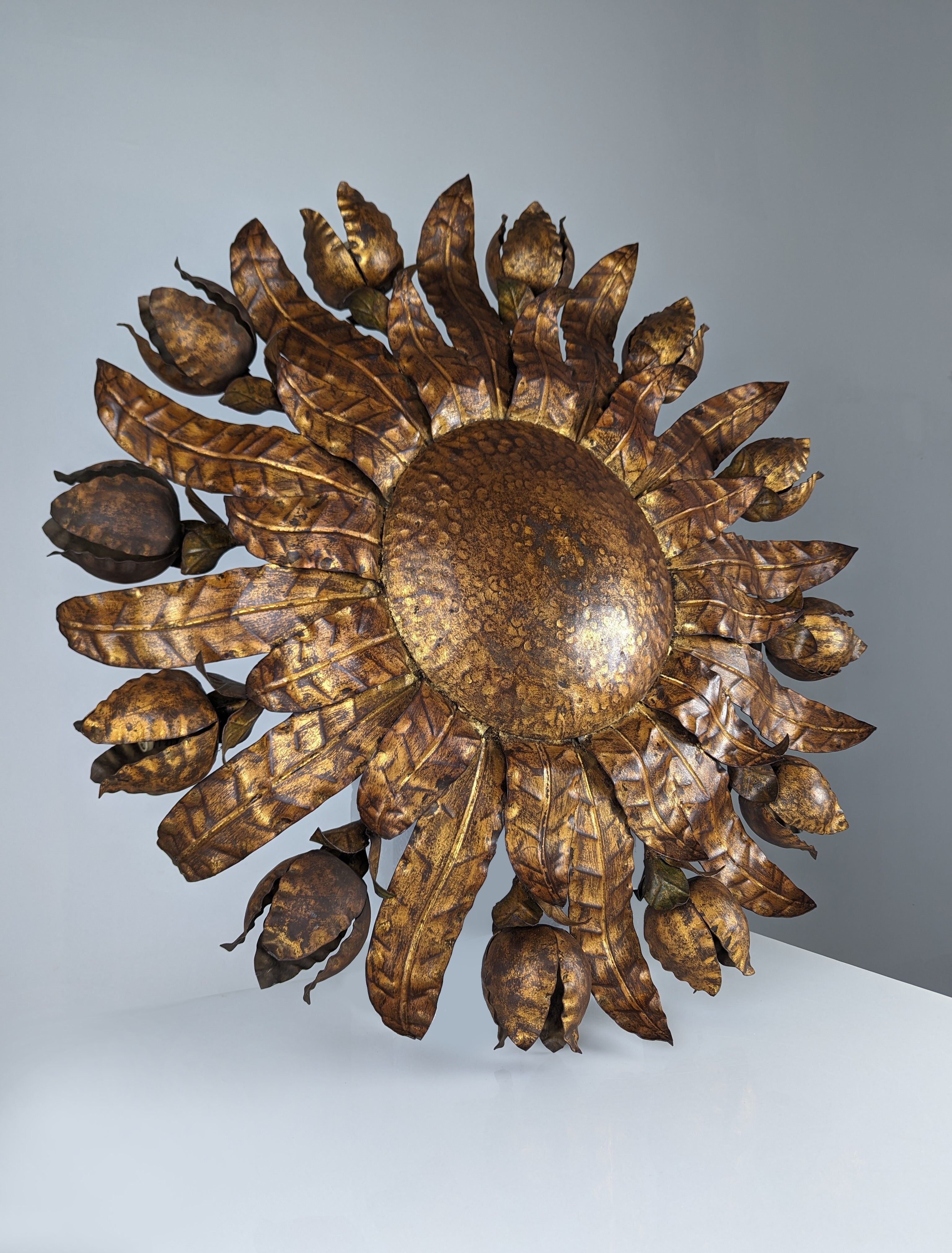 Large mid-century sunburst ceiling lamp, gilded metal with floral motif, 1950s