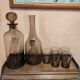 Table service set with a carafe, bottle, and 5 glass cups.
