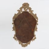 French Rococo or Baroque style facet-cut crest mirror in gilded carved wood