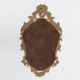French Rococo or Baroque style facet-cut crest mirror in gilded carved wood