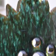 Green ceramic sun candlestick from Tamegroute, Morocco.