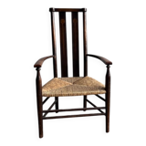 Dark brown solid wood Arts & Crafts armchair with natural rush seat and high back