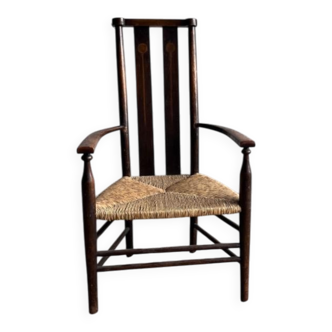 Dark brown solid wood Arts & Crafts armchair with natural rush seat and high back