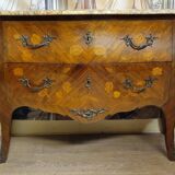 Curved Louis XV style commode with floral marquetry and marble top.