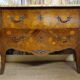 Curved Louis XV style commode with floral marquetry and marble top.