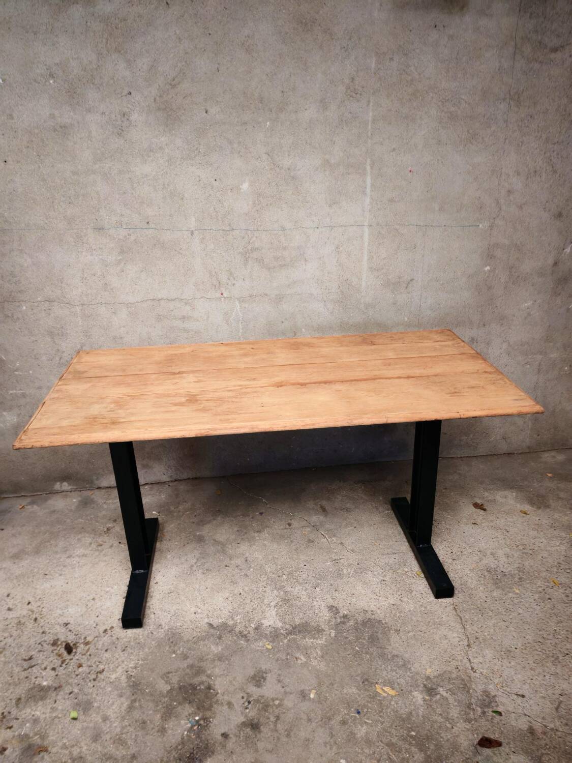 Unique wooden table with metal industrial legs.