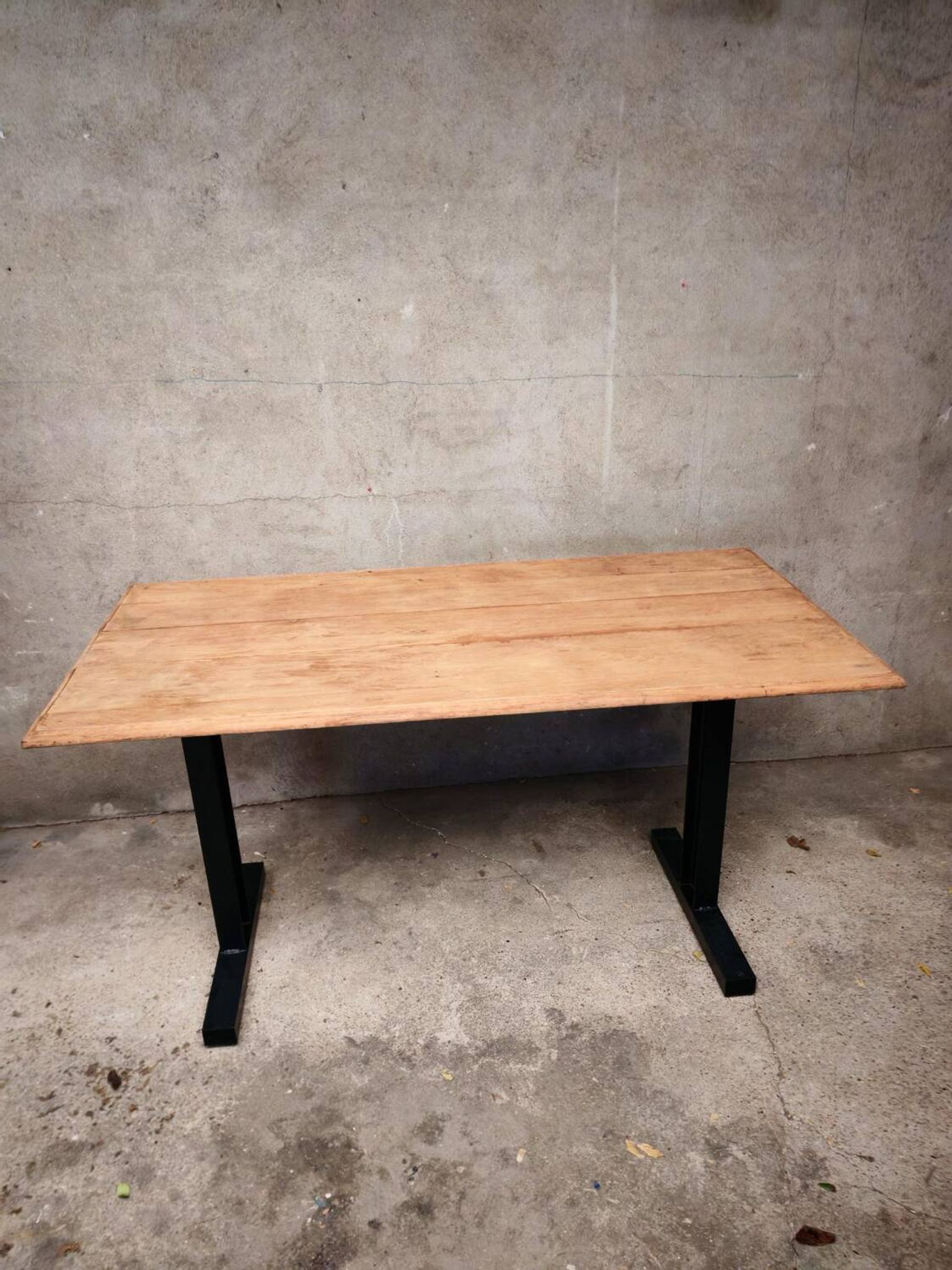 Unique wooden table with metal industrial legs.