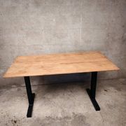 Unique wooden table with metal industrial legs.