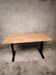 Unique wooden table with metal industrial legs.