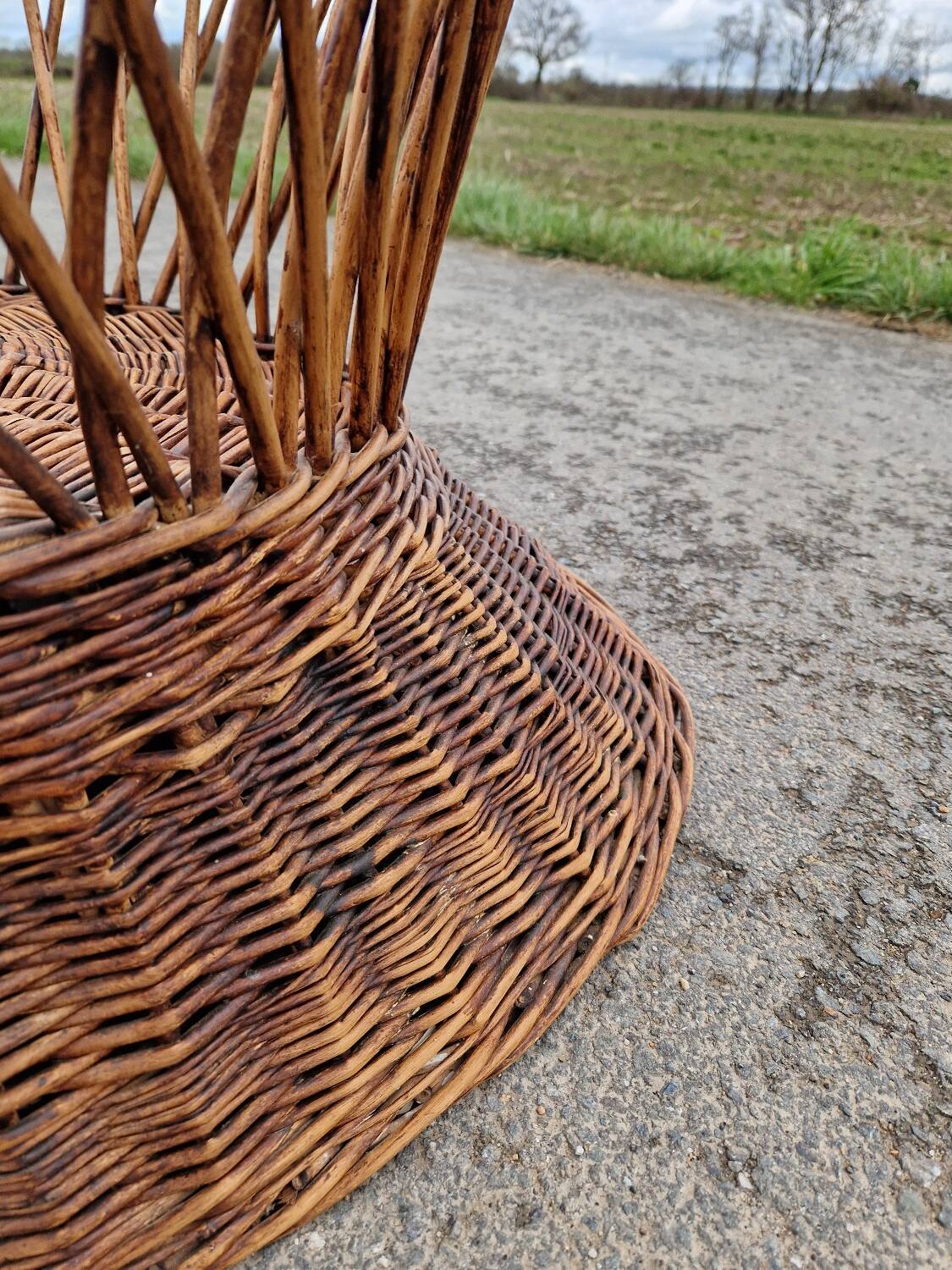 Old throne basket armchair in woven wicker