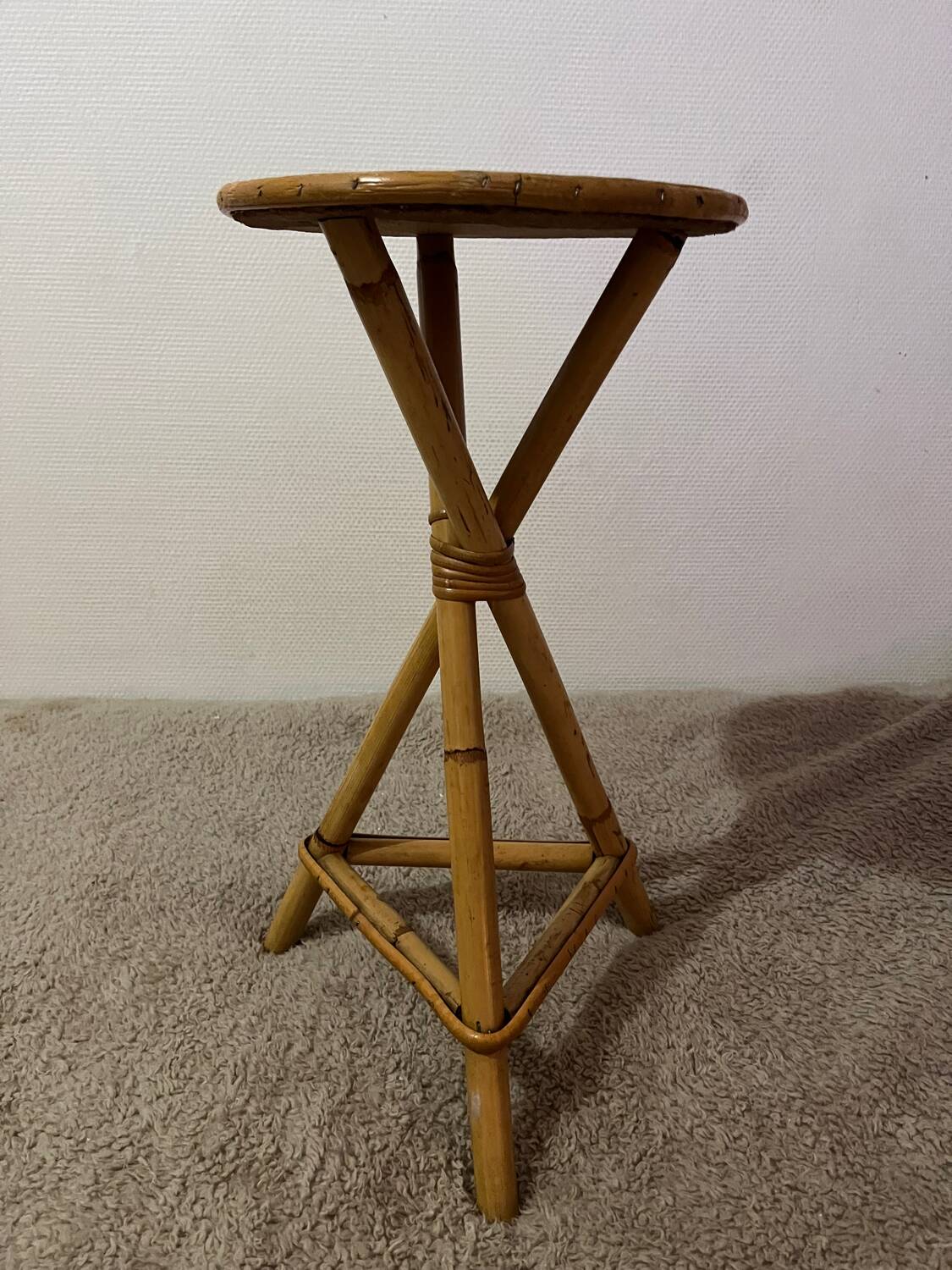 Plant holder or side table at the end of a bamboo sofa