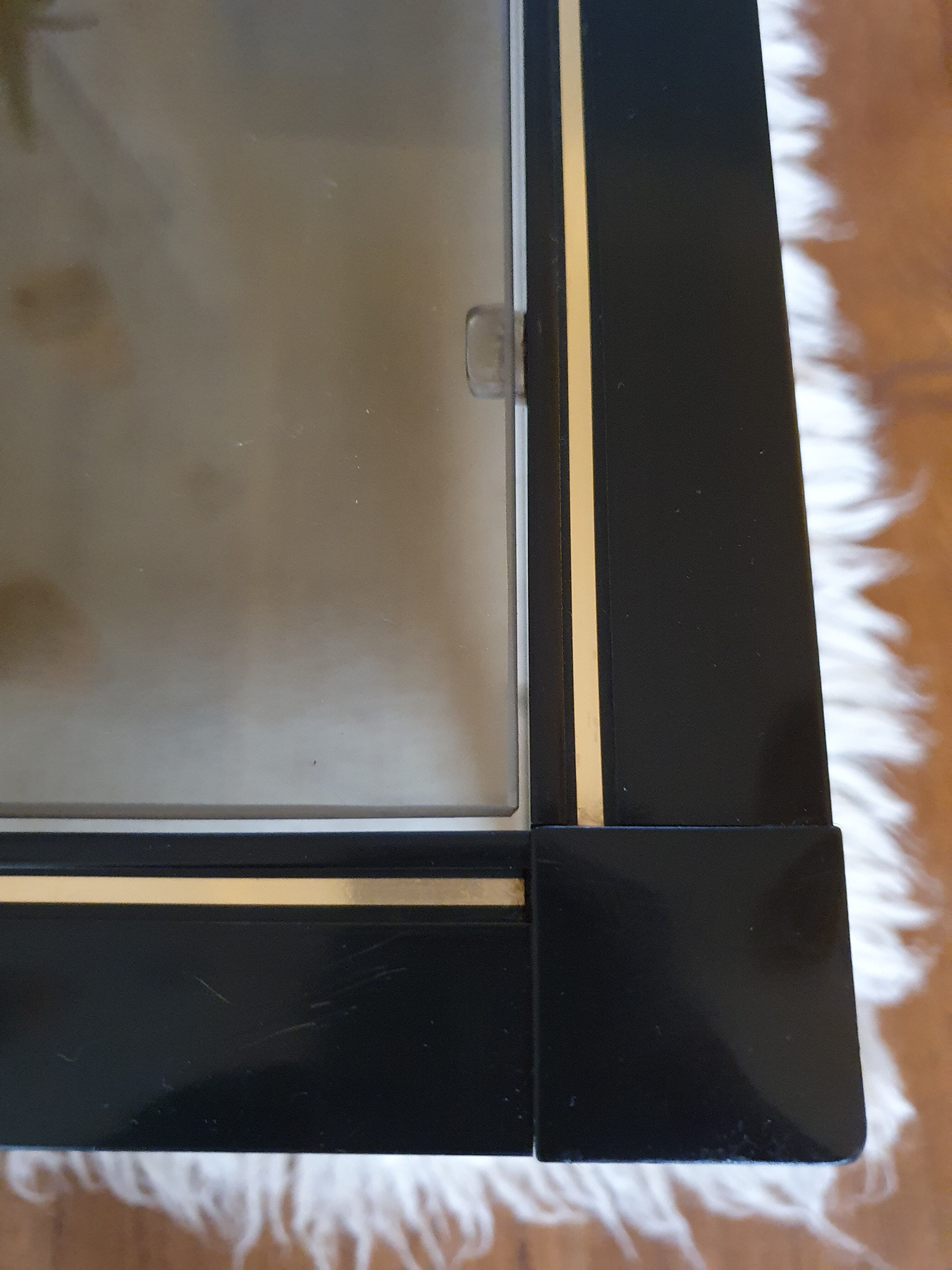 Black and gold coffee table with a double smoked glass top