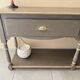 Wall-mounted console in wood, grey lacquer with a highlighted edge.