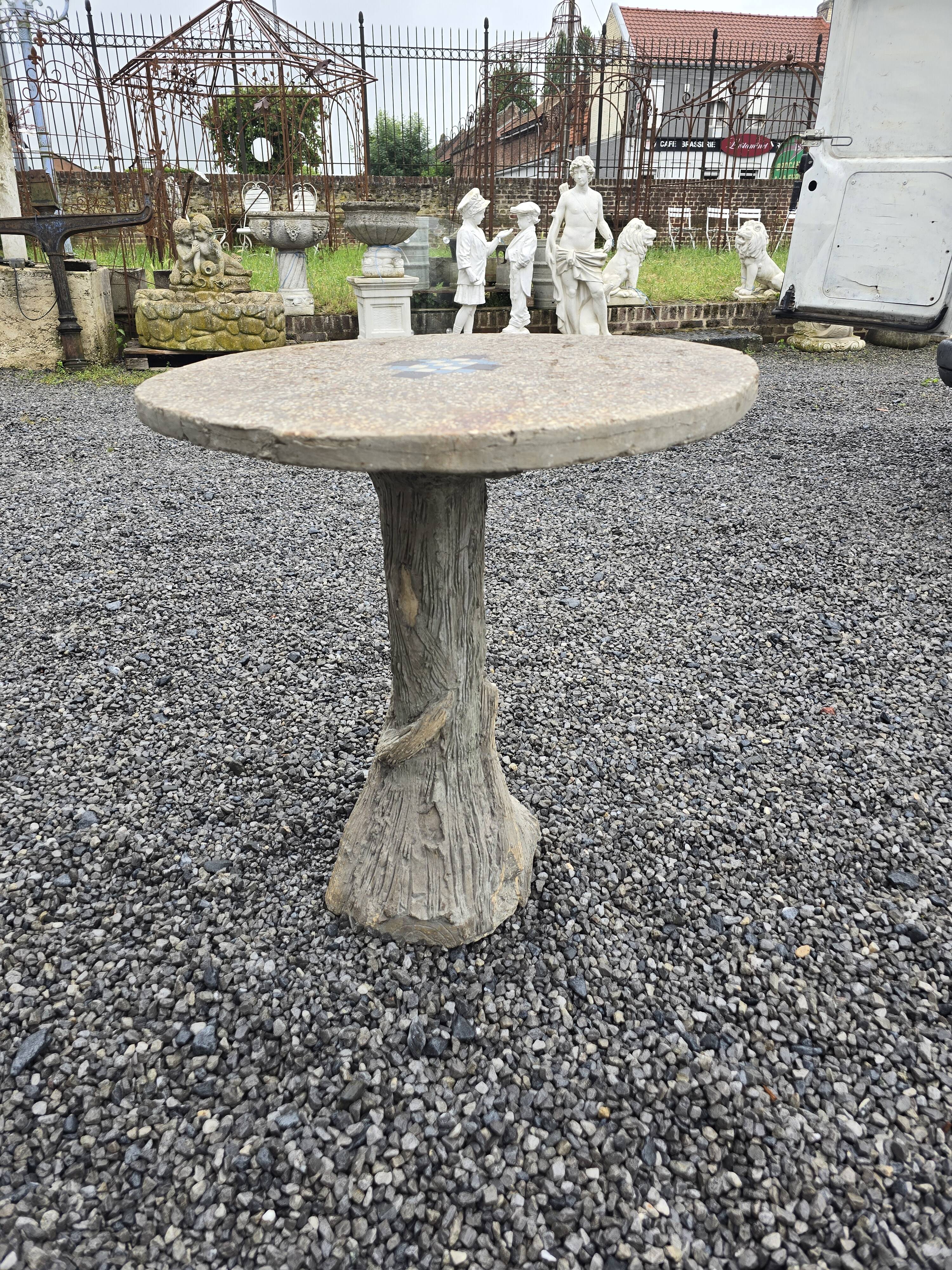 Cement garden table with trunk-shaped foot