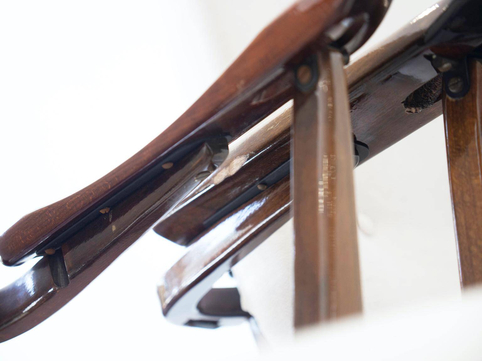 Pair of varnished wooden reclining armchairs, upholstered in lightweight fabric.