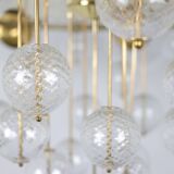 Large chandelier in gilded brass with decorative balls. 1970s.