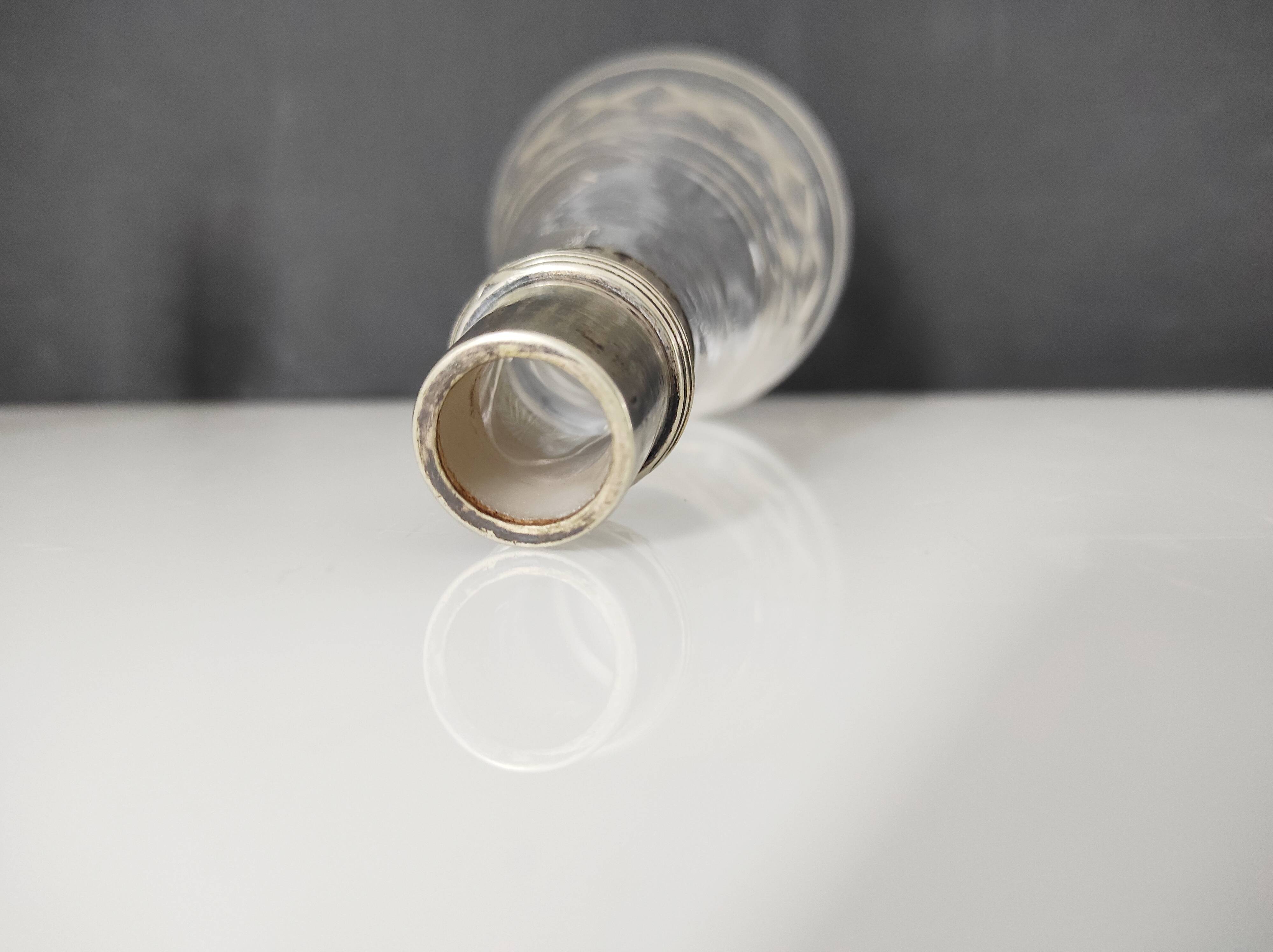 Crystal bottle with silver metal neck rim