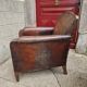 Antique club chair in patinated brown leather, early 20th century English style.