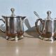 Two small silver-plated metal tea service pots from the 20th century.