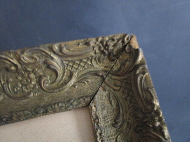 Bouquet of flowers with old wooden frame and gilded stucco