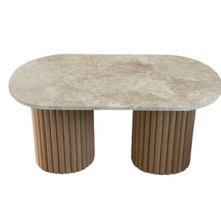 Oval coffee table in travertine and raw fluted wood.