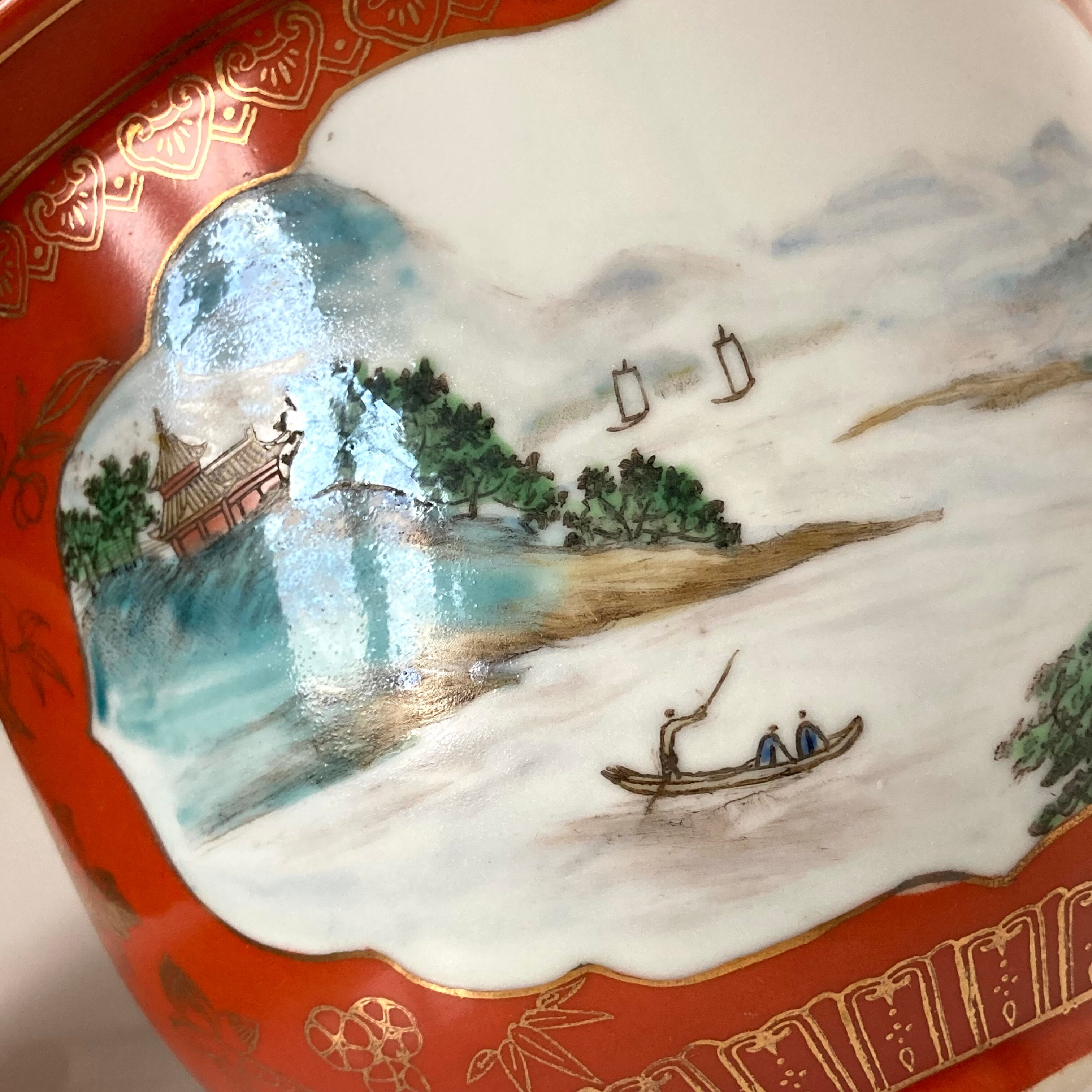Chinese planter or Chinese porcelain pot cover decorated with landscapes on a coral and golden background
