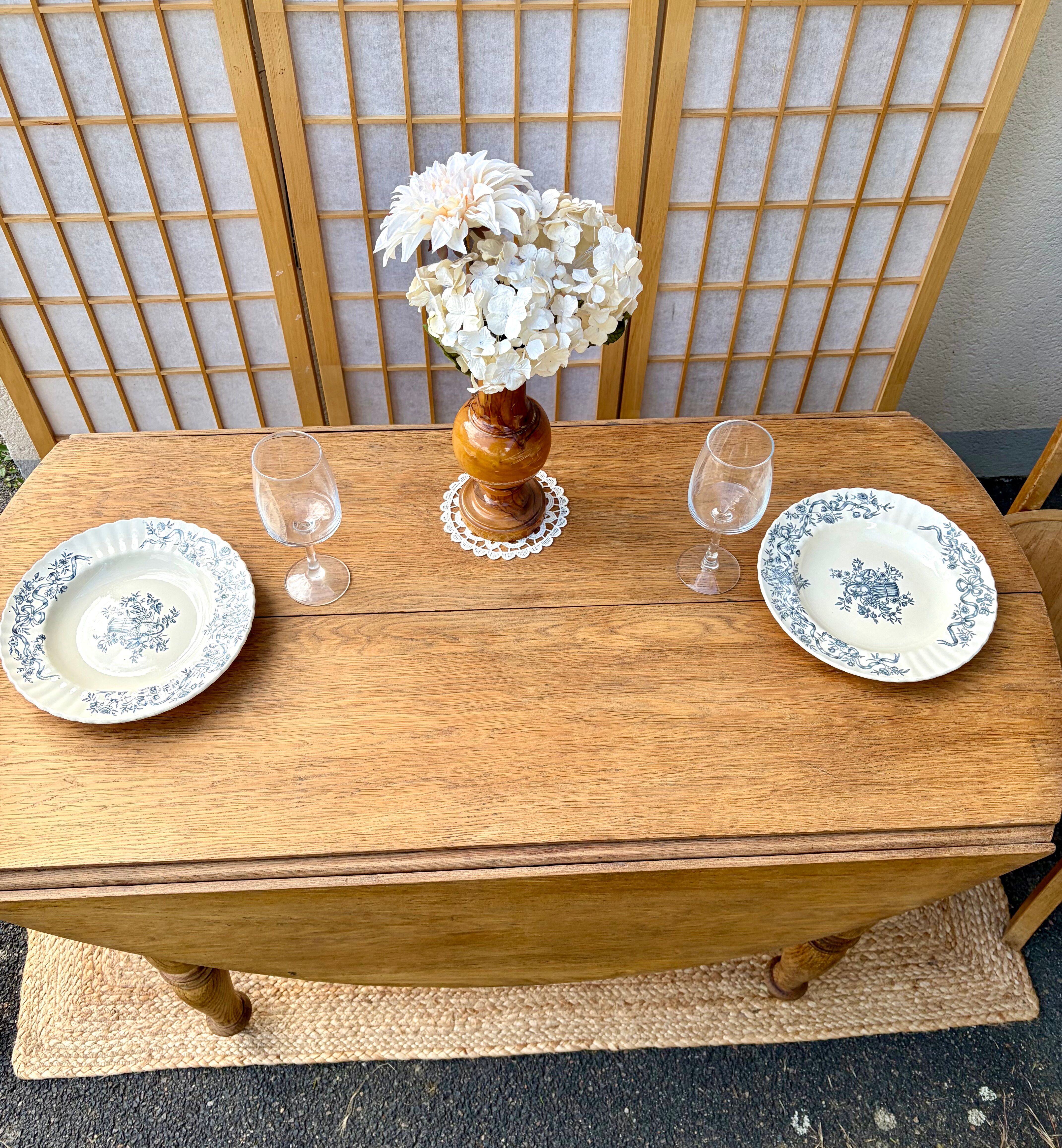 Round oak table with a drop leaf.