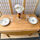 Round oak table with a drop leaf.