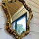 Vintage wall mirror in Louis XV / Baroque style – Carved wooden frame in gold.