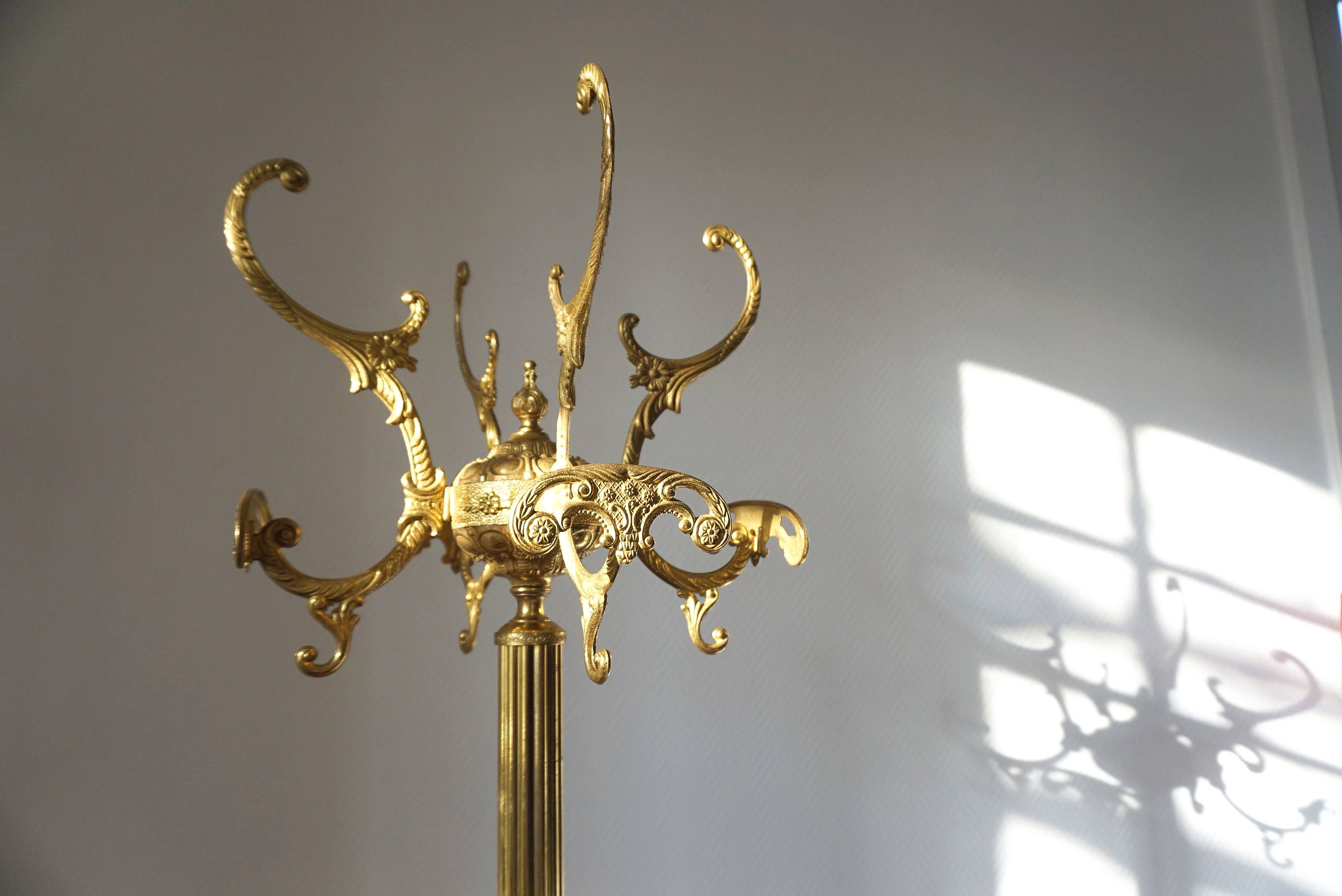 Turning brass coat rack