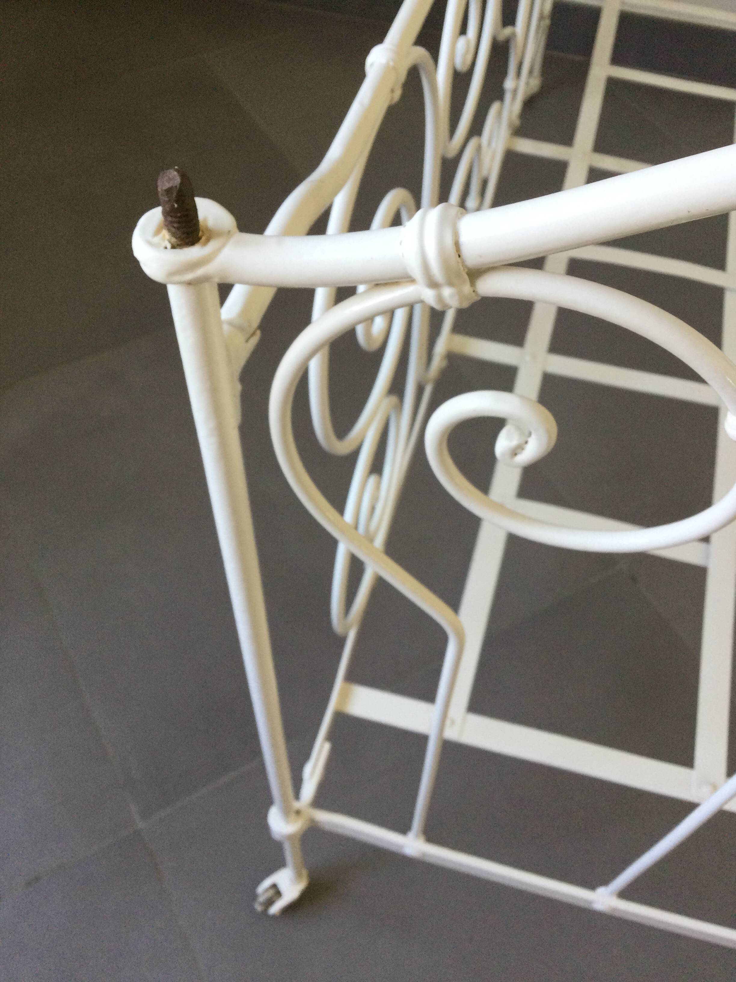 White wrought iron folding bed