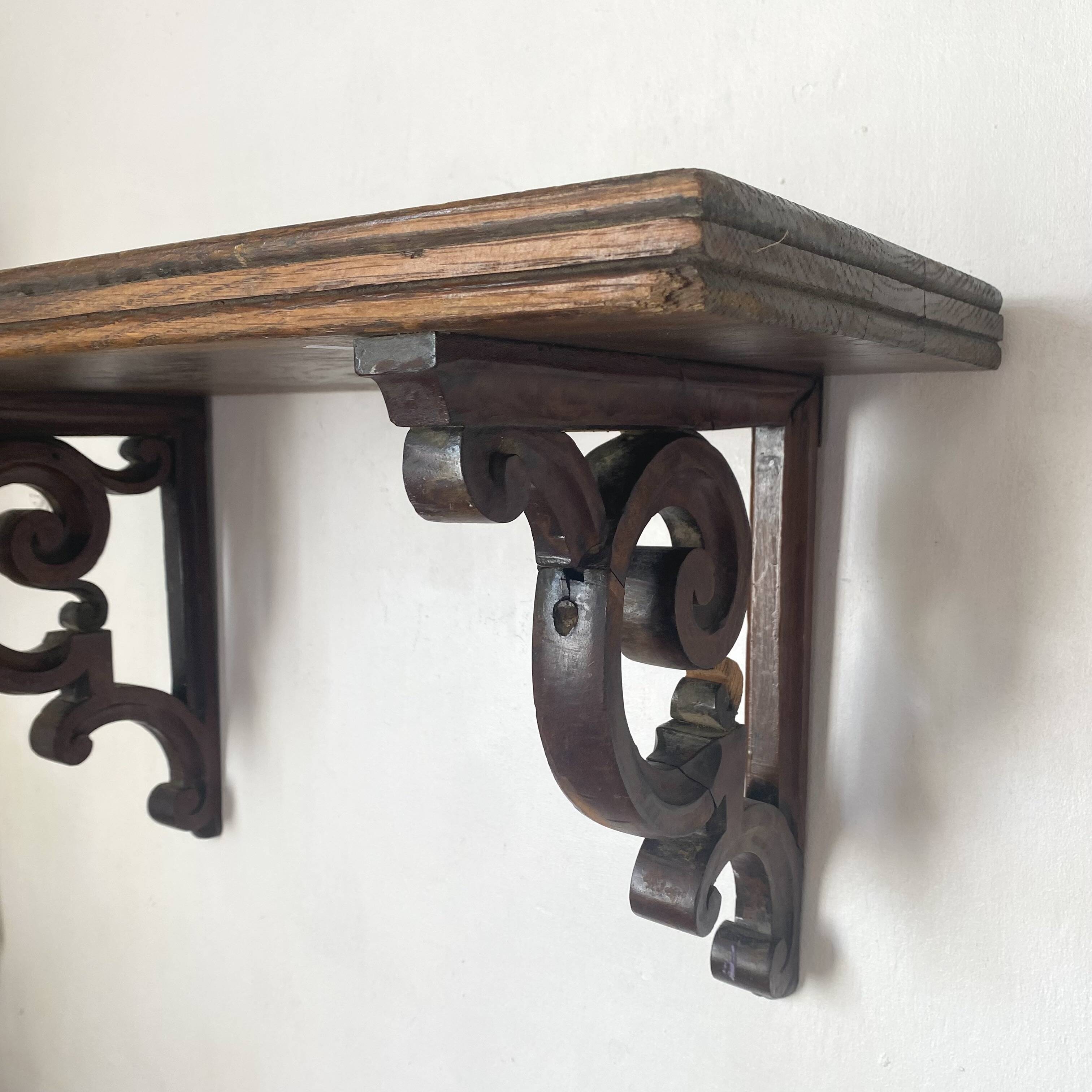 antique oak wall shelf with carved brackets