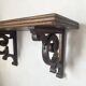 antique oak wall shelf with carved brackets