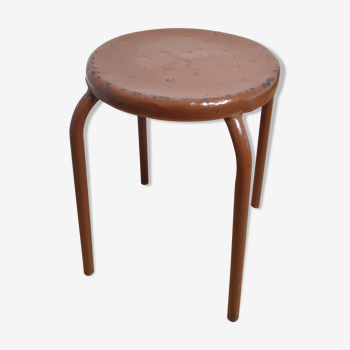 Rust-colored painted metal stool