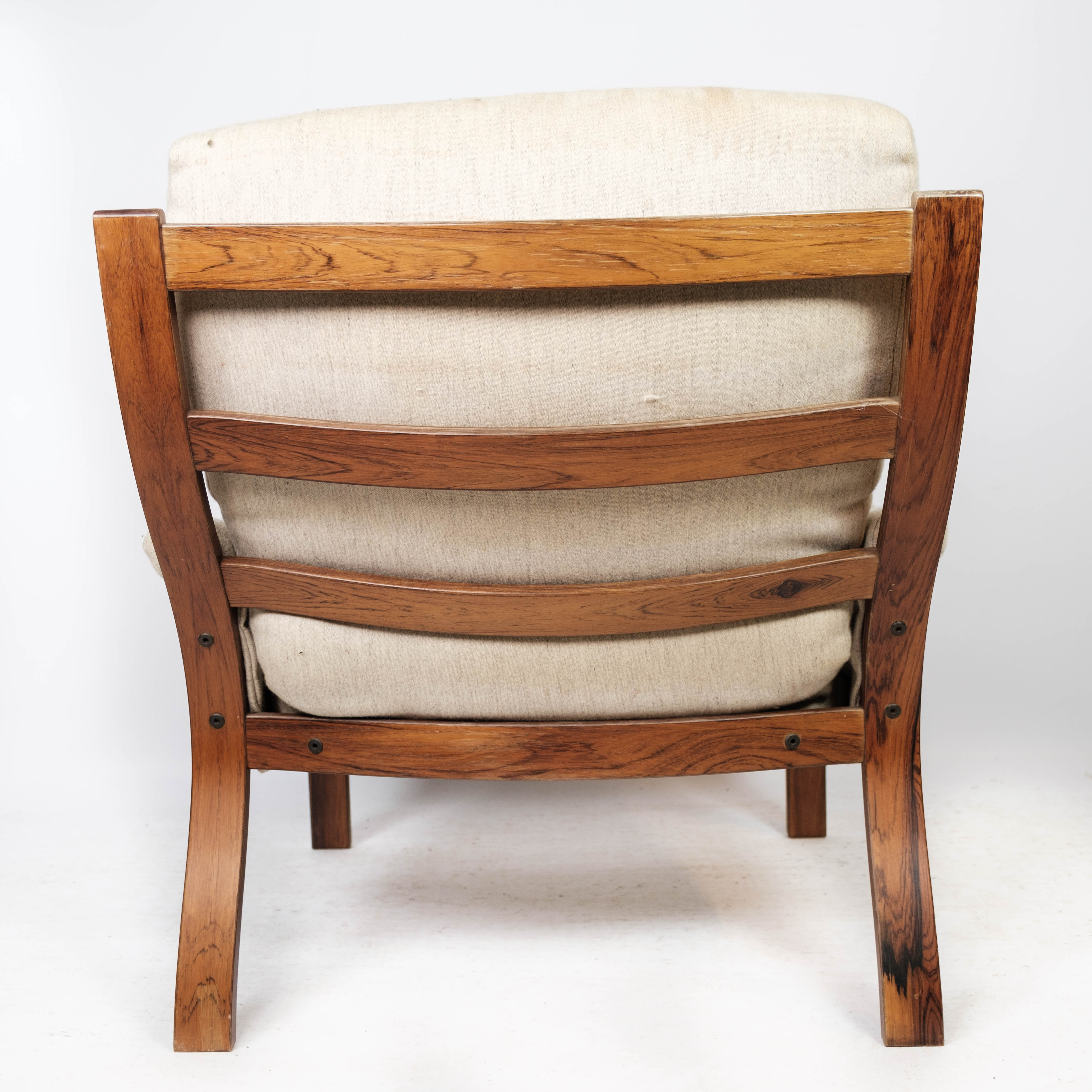Armchair in rosewood and upholstered with light fabric, of Danish design, 1960s