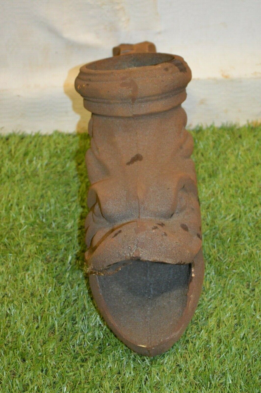 Cast iron gutter downspout in the shape of a dolphin