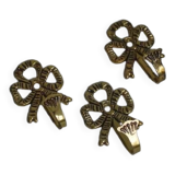 Trio of brass coat hooks